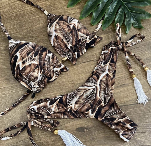 Women's tropical floral print bikini with a halter top, ruffled edges, and tie-side bottoms with pink tassels. - Image 17