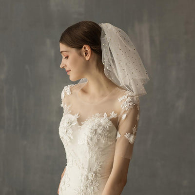 White multi-layer short bridal veil with gold star embellishments, worn by a model in a white lace wedding dress. - Image 5