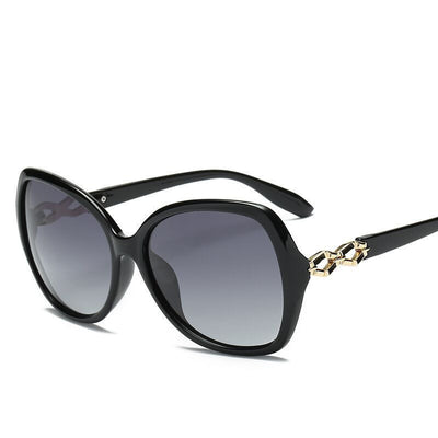Women's purple oversized polarized sunglasses with gradient lenses and gold chain link detail on the temples. - Image 5