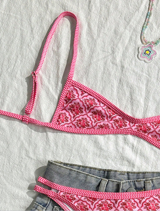 Pink two-piece bikini with a red floral and geometric print, featuring a bandeau top and high-cut bottoms. - Image 4