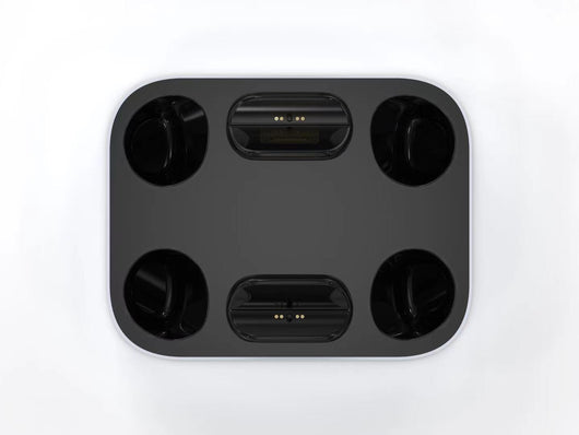 White and black dual charging dock for PS5 gamepads, featuring two charging ports and two storage slots. - Image 4