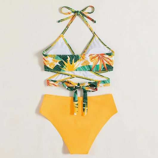 Women's two-piece swimsuit with a green, yellow, and orange tropical floral print halter top and solid yellow high-waisted bikini bottoms. - Image 3