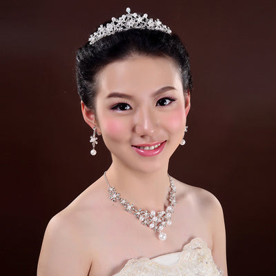 Bridal jewelry set with a silver-tone necklace and matching drop earrings, featuring crystal flowers and faux pearls. - Image 3