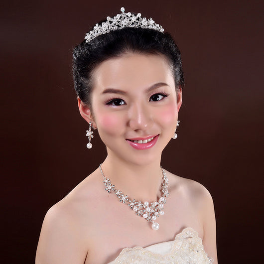 Bridal jewelry set with a silver-tone necklace and matching drop earrings, featuring crystal flowers and faux pearls. - Image 3