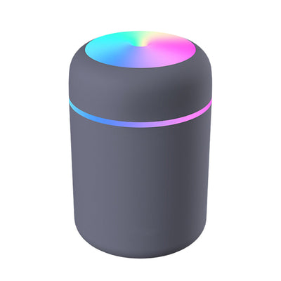 Dark gray ultrasonic aromatherapy essential oil diffuser with a colorful LED light band and rainbow top light. - Image 20