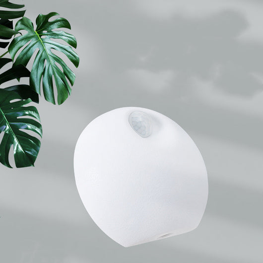 White spherical smart pet deodorizer with a sensor, designed for litter basins, shown against a light gray background with green leaves. - Image 3