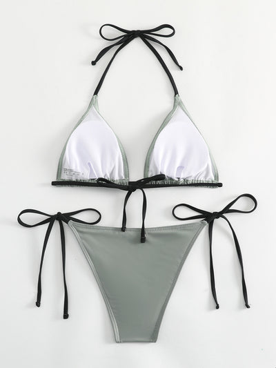 Neon yellow halter bikini with triangle top and tie-side bottoms, displayed on a light wood surface. - Image 38
