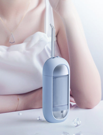 White portable electric dental water flosser with a clear nozzle and retractable water tank for oral hygiene. - Image 15