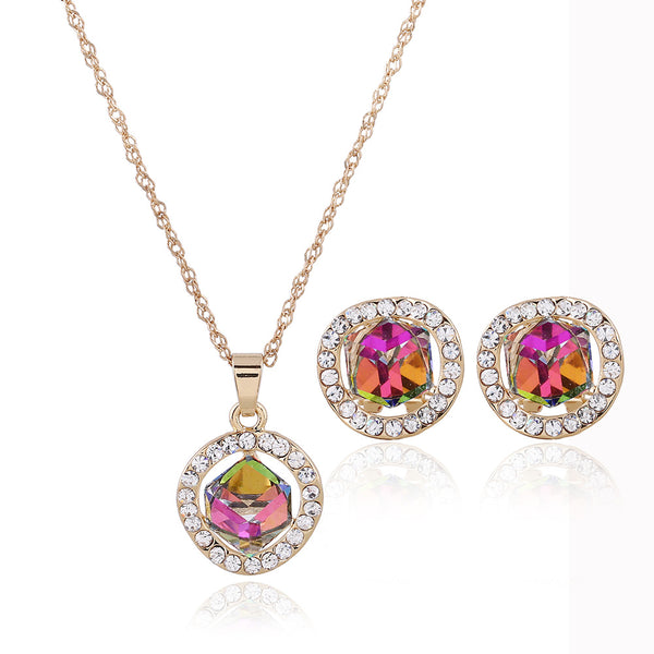 Gold-colored necklace and stud earrings set with iridescent multi-faceted crystal pendants surrounded by clear crystals.