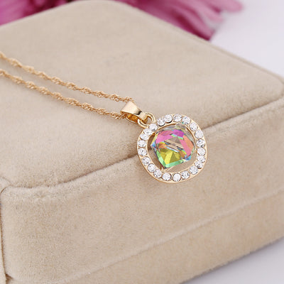 Gold-colored necklace and stud earrings set with iridescent multi-faceted crystal pendants surrounded by clear crystals. - Image 5