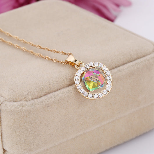 Gold-colored necklace and stud earrings set with iridescent multi-faceted crystal pendants surrounded by clear crystals. - Image 5