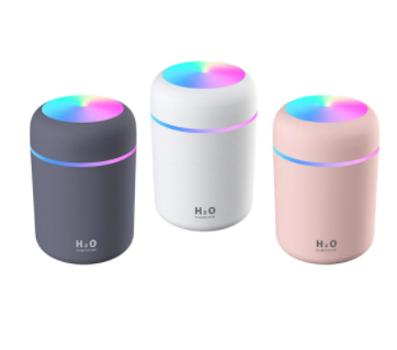 Pink ultrasonic aromatherapy essential oil diffuser with a colorful LED light band and top light, labeled H2O Humidifier.