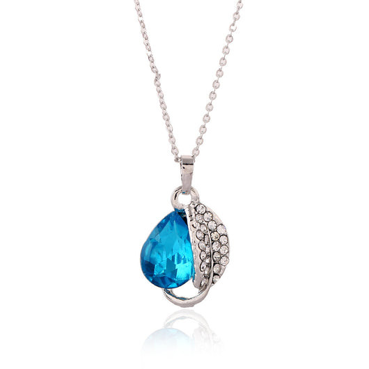 Silver-tone jewelry set with teardrop blue gemstones and clear rhinestones, including a necklace, bracelet, and earrings. - Image 3