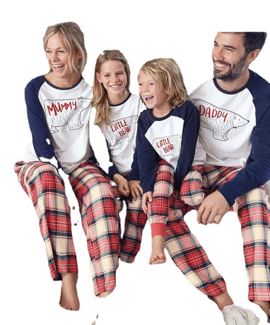Family of four wearing matching Christmas pajamas with white and navy bear print tops and red plaid pants. - Image 5