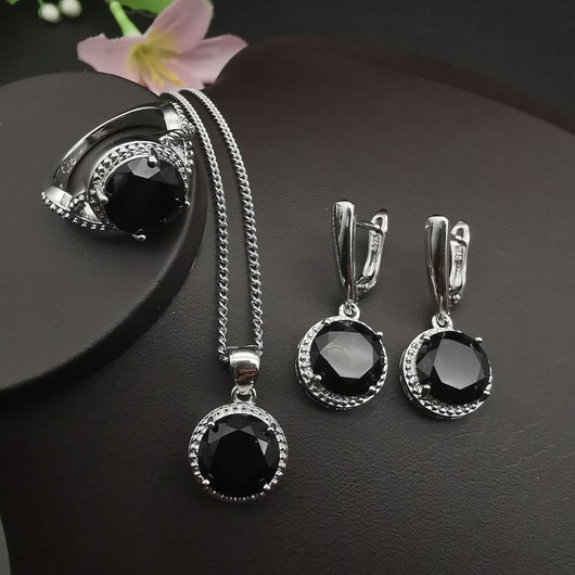 Four-piece silver-tone jewelry set with round green gemstones, including a necklace, bracelet, ring, and dangle earrings. - Image 17