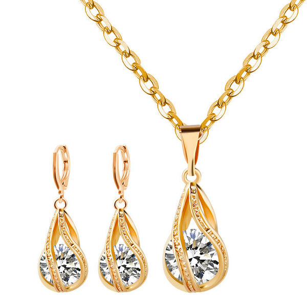 Silver teardrop necklace and matching drop earrings set with clear zircon gemstones, ideal for a bride or wedding.