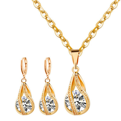 Silver teardrop necklace and matching drop earrings set with clear zircon gemstones, ideal for a bride or wedding.