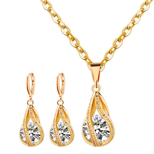 Silver teardrop necklace and matching drop earrings set with clear zircon gemstones, ideal for a bride or wedding.