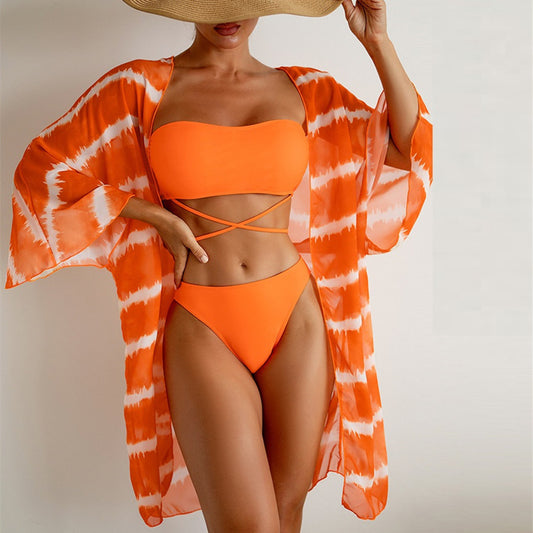 Women's orange and white tie-dye chiffon three-piece swimsuit with a bandeau bikini top and matching bottoms.