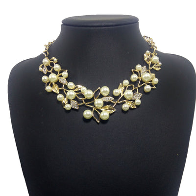 Gold-toned necklace and matching earrings set with faux pearls and clear rhinestones in an elegant leaf and vine design. - Image 3