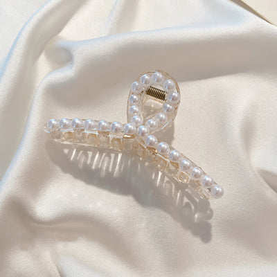 Clear plastic hair claw clip adorned with a single row of white faux pearls and a gold-toned spring. - Image 5