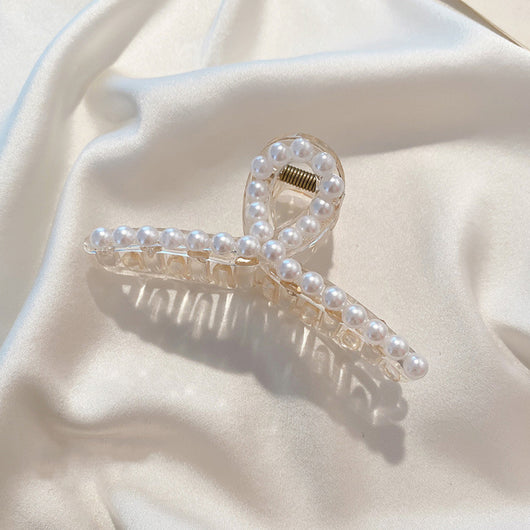 Clear plastic hair claw clip adorned with a single row of white faux pearls and a gold-toned spring. - Image 5