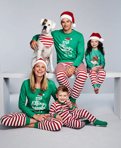 Kids' green long-sleeve Christmas pajama top with an elf graphic and matching red and white striped pants.
