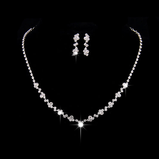 Simple rhinestone bridal necklace and matching drop earrings set, perfect for a wedding or formal occasion.