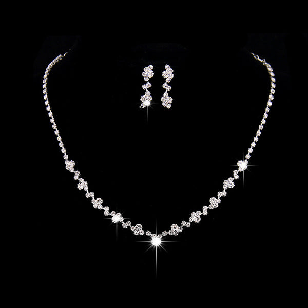 Simple rhinestone bridal necklace and matching drop earrings set, perfect for a wedding or formal occasion.
