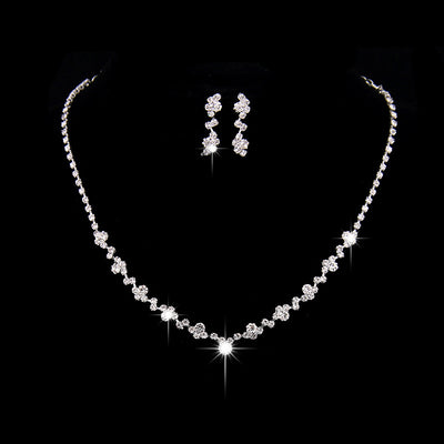 Simple rhinestone bridal necklace and matching drop earrings set, perfect for a wedding or formal occasion.