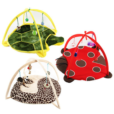 Giraffe print cat playing bed with a plush mat, an overhead arch, and hanging crocheted bird, spotted ball, and mouse toys.