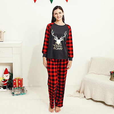 Woman wearing a Christmas pajama set with a dark gray 'Merry Christmas MOMMY' reindeer top and red and black plaid pants. - Image 2