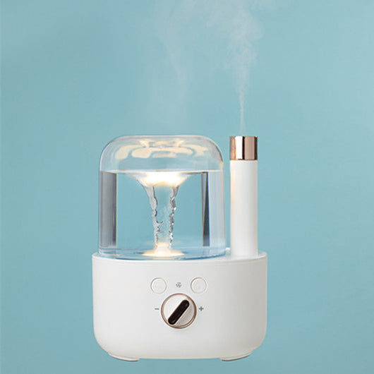 White and clear humidifier with a visible water vortex, emitting mist, and featuring a rose gold accent. - Image 6
