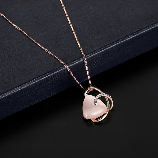 Rose gold-toned necklace and stud earrings set with triangular pink stones and clear rhinestone accents. - Image 11