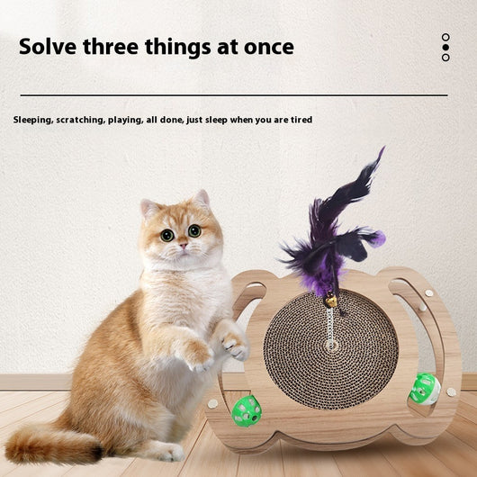Multi-level cat scratcher with a round corrugated cardboard surface, a wooden track with a green ball, and a pink feather wand with a bell. - Image 3