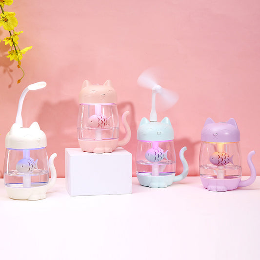 Pink cat-shaped USB humidifier with a clear body, decorative fish, and cute cat features like ears, paws, and tail.