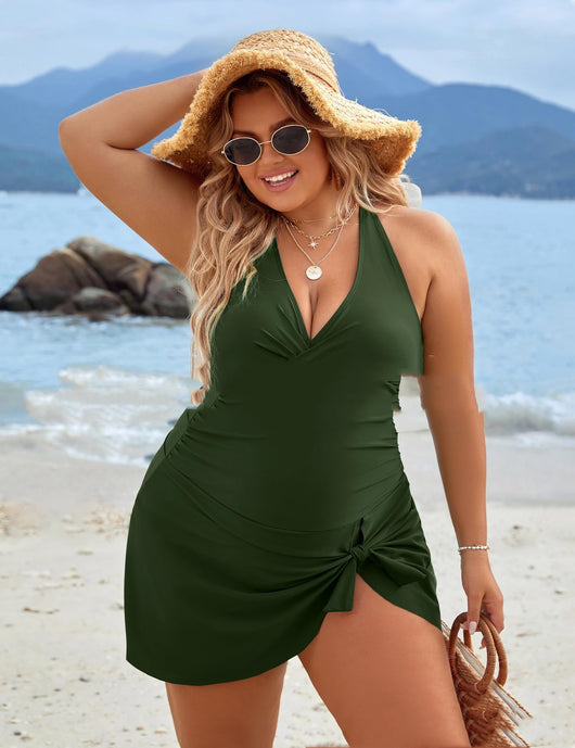 Plus size woman wearing a black one-piece skirted swimsuit with a halter neckline and side tie knot detail. - Image 11