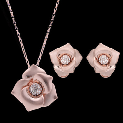 Rose gold-toned necklace and stud earrings set with floral design and clear rhinestone accents. - Image 2