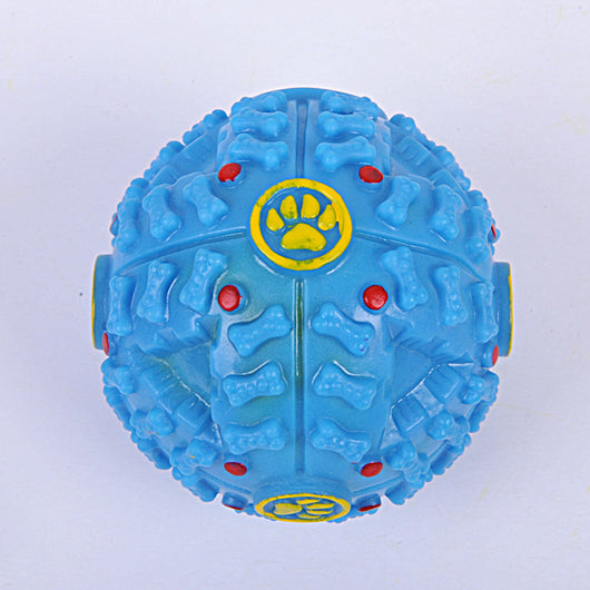 Blue rubber dog toy ball with bone-shaped nubs, red dots, and yellow paw print accents, designed for treats. - Image 4