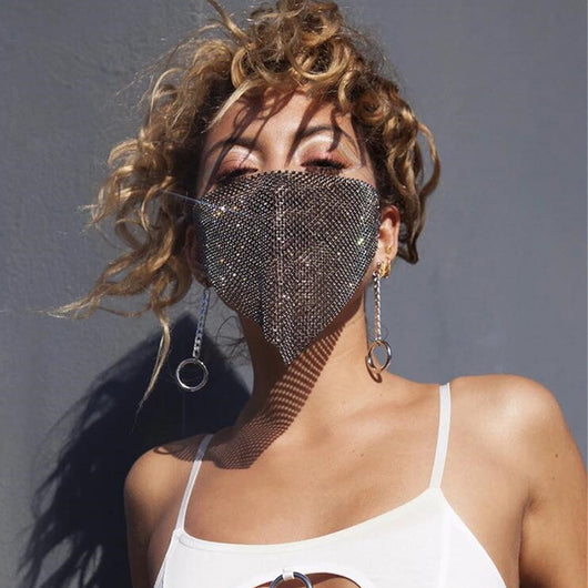 Gold rhinestone mask made of metal mesh, covering the face from the eyes to below the chin, displayed on a white mannequin head.