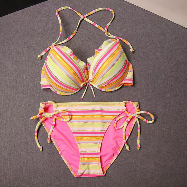 Colorful striped lace-up bikini swimsuit with a ruffled halter top and matching tie-side bottoms.