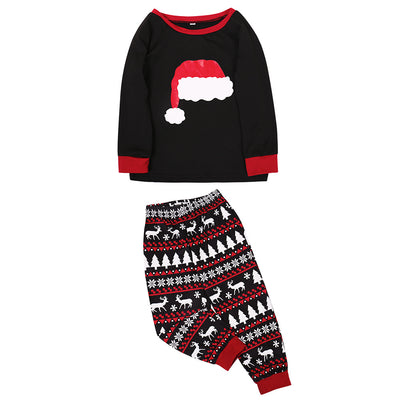Family of four in black and red matching Christmas pajamas with Santa hat tops and fair isle pants. Also shown: a two-piece set and a baby romper. - Image 7
