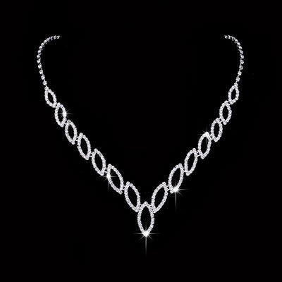 Sparkling silver-tone necklace and dangle earrings set with marquise-shaped rhinestone links for weddings or formal events. - Image 2
