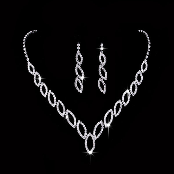 Sparkling silver-tone necklace and dangle earrings set with marquise-shaped rhinestone links for weddings or formal events.