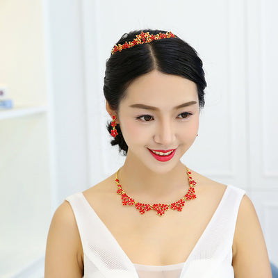 Sparkling crystal bridal jewelry set with floral necklace, drop earrings, and a matching tiara on a bride. - Image 4