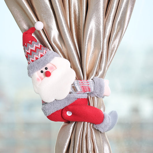 Plush Santa Claus curtain tie-back with a red and grey knitted hat, white beard, and red body, holding a golden curtain.