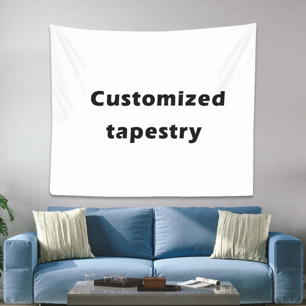 White customizable tapestry with "Customized tapestry" text, hanging on a gray wall above a blue sofa.