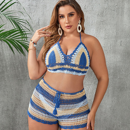 Woman in a blue and white striped crochet two-piece swimsuit with a halter top and high-waisted shorts.