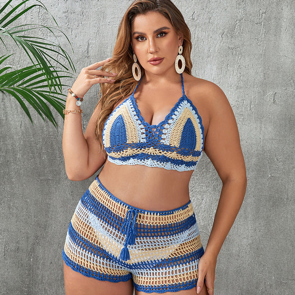 Woman in a blue and white striped crochet two-piece swimsuit with a halter top and high-waisted shorts.