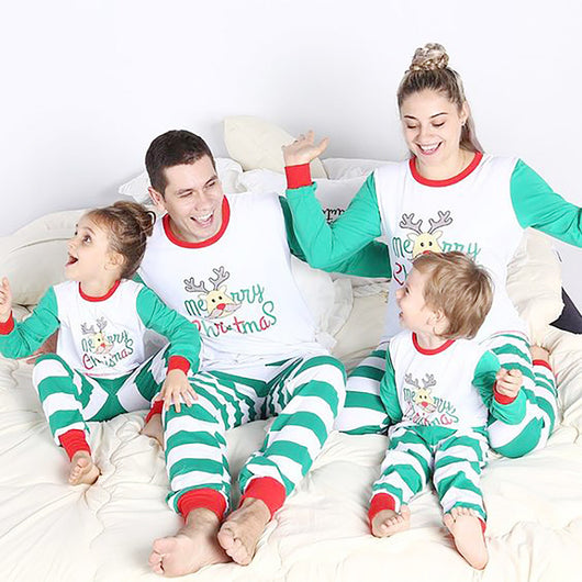 Family of four wearing matching green and white striped Christmas pajamas with a reindeer and "Merry Christmas" text. - Image 2